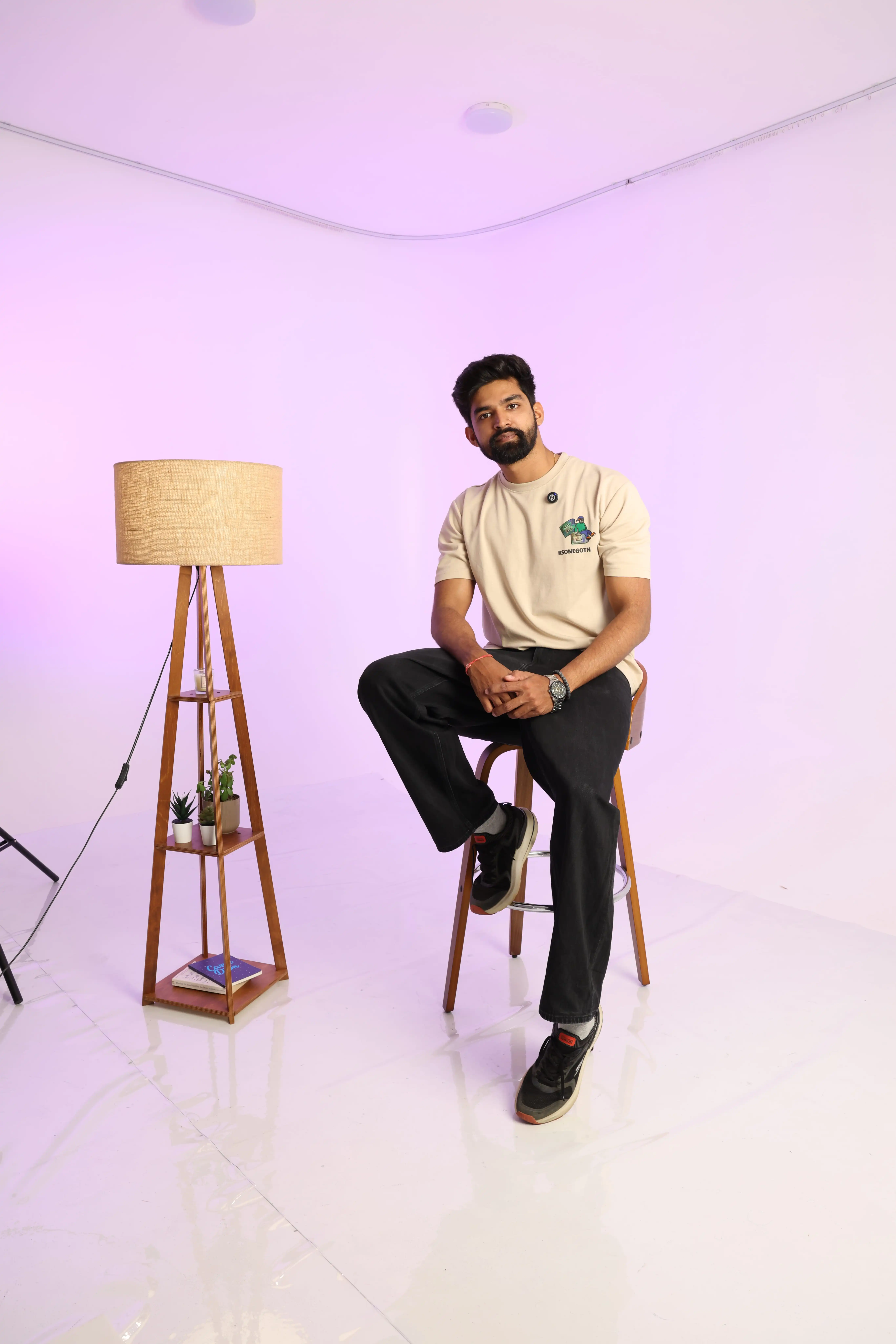 Studio founder holding camera with warm smile in photography studio