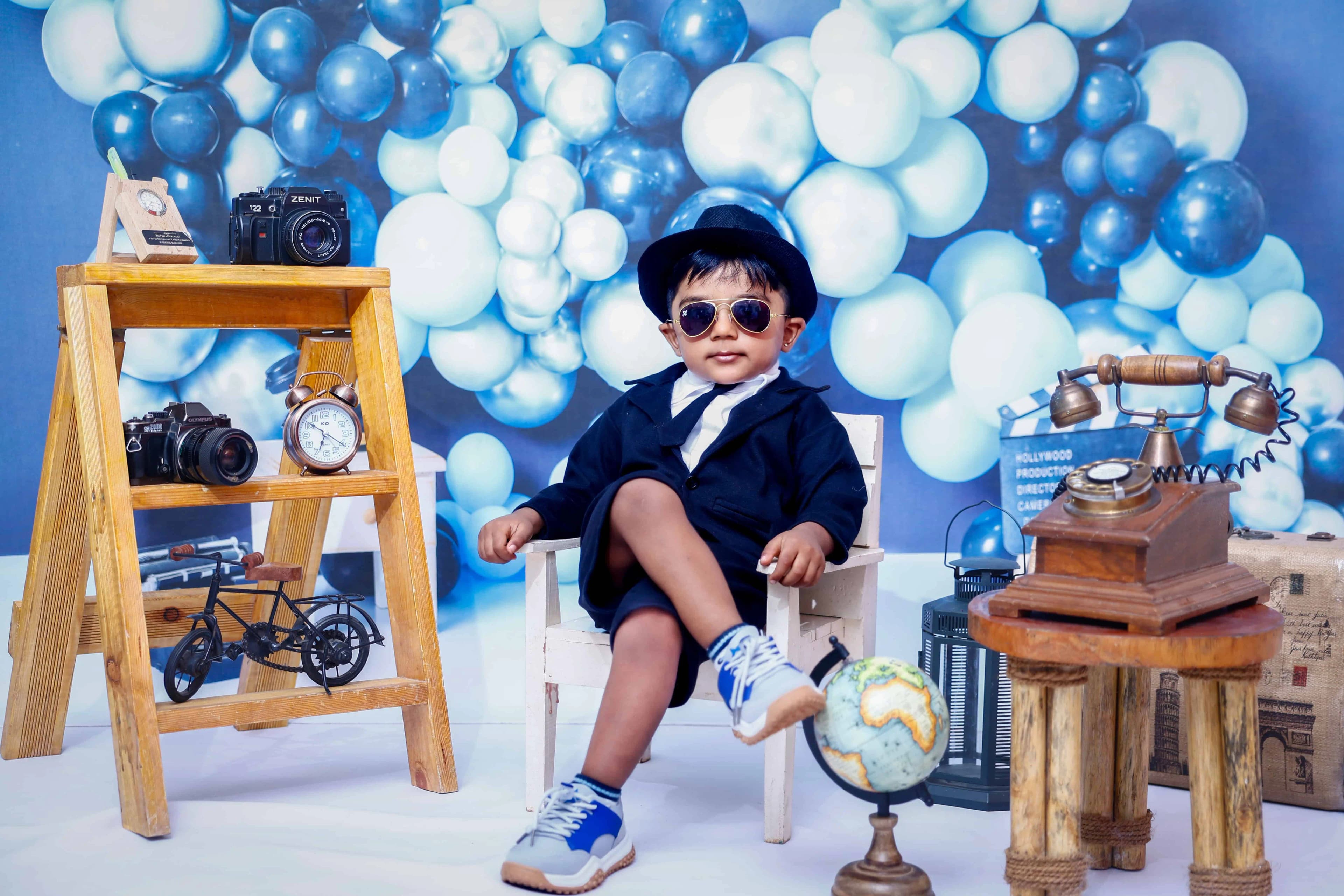 Happy toddler laughing near musical instruments in studio