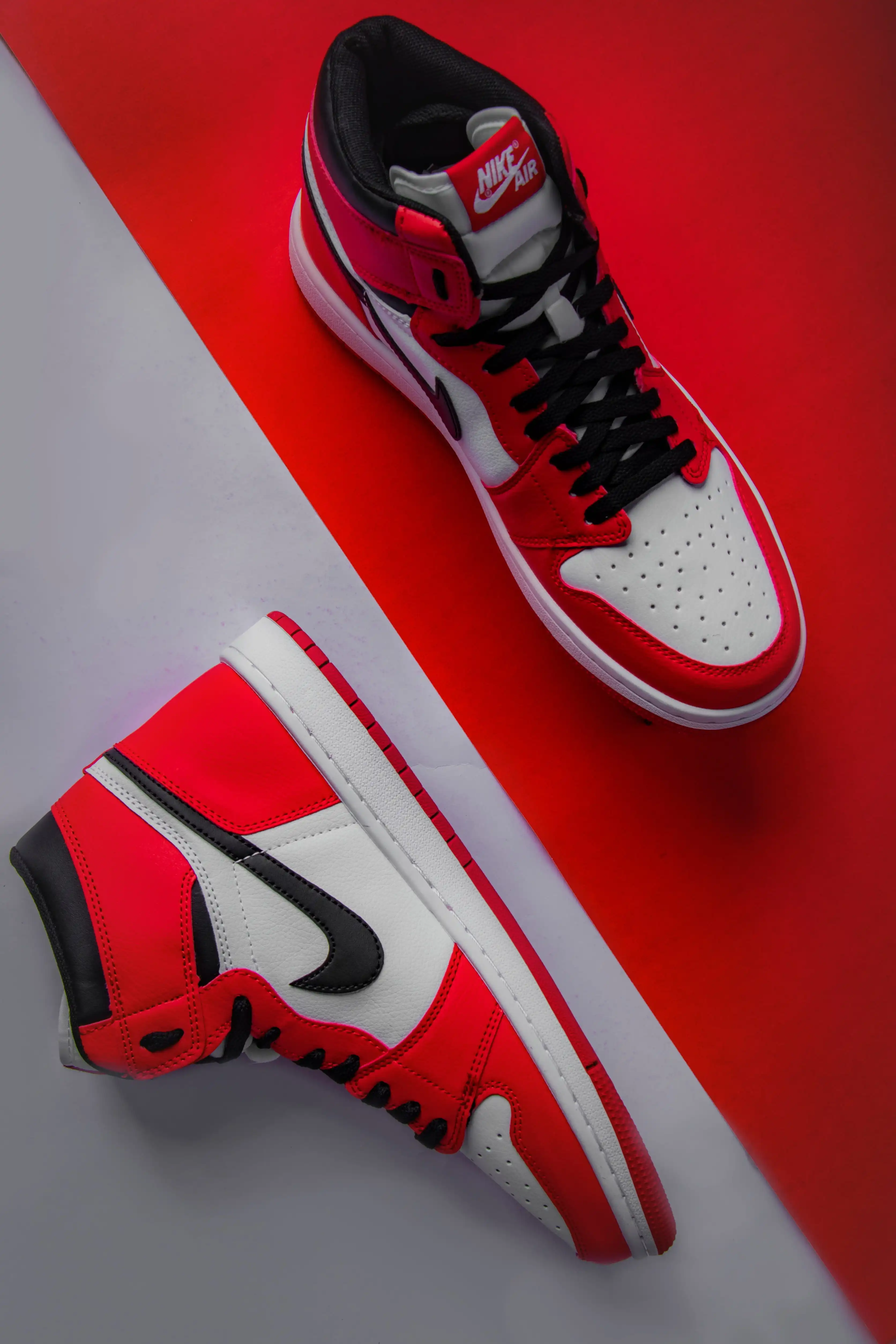 Luxury watch on marble surface with dramatic lighting and reflections