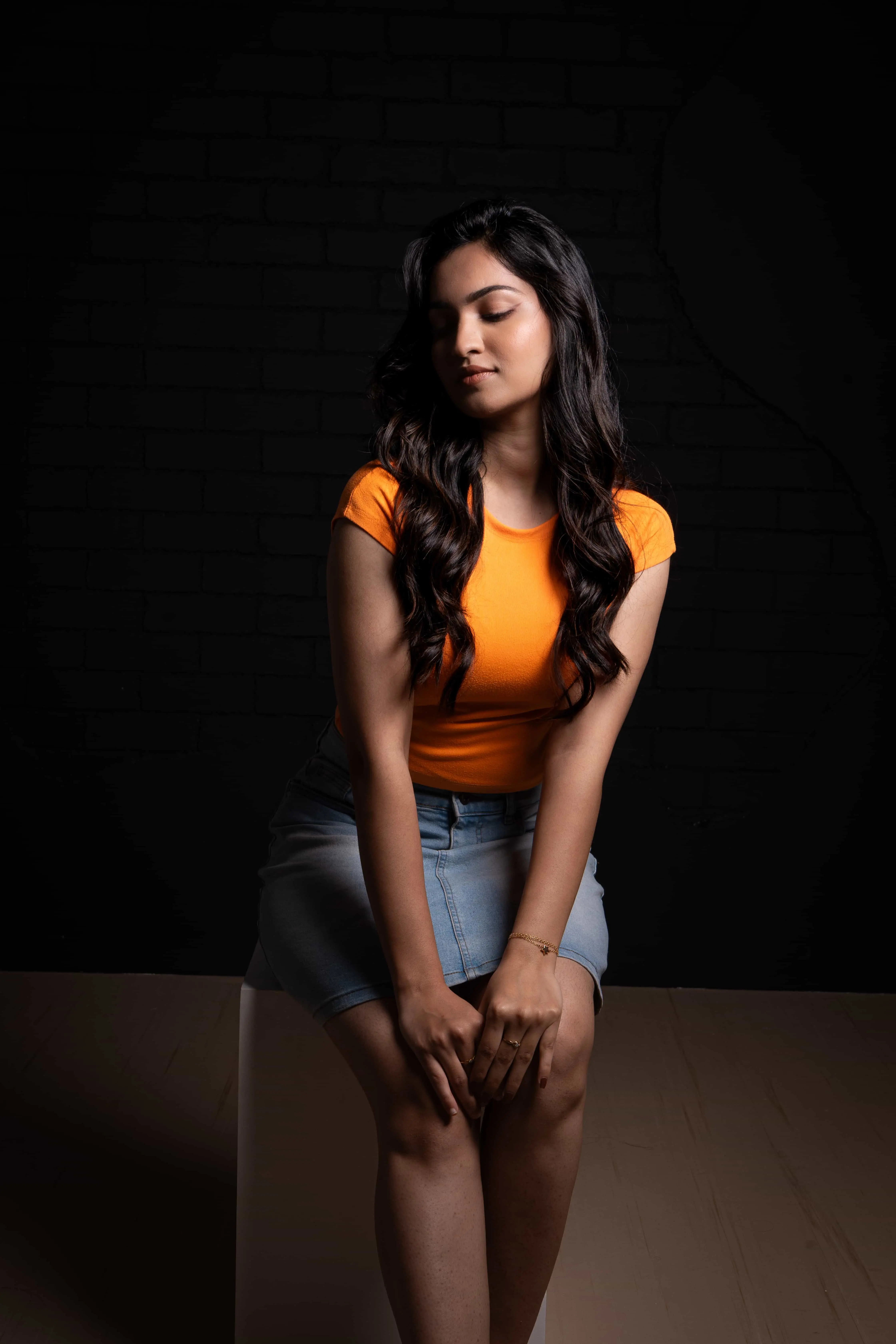 Fashion model in red evening gown with dramatic studio lighting